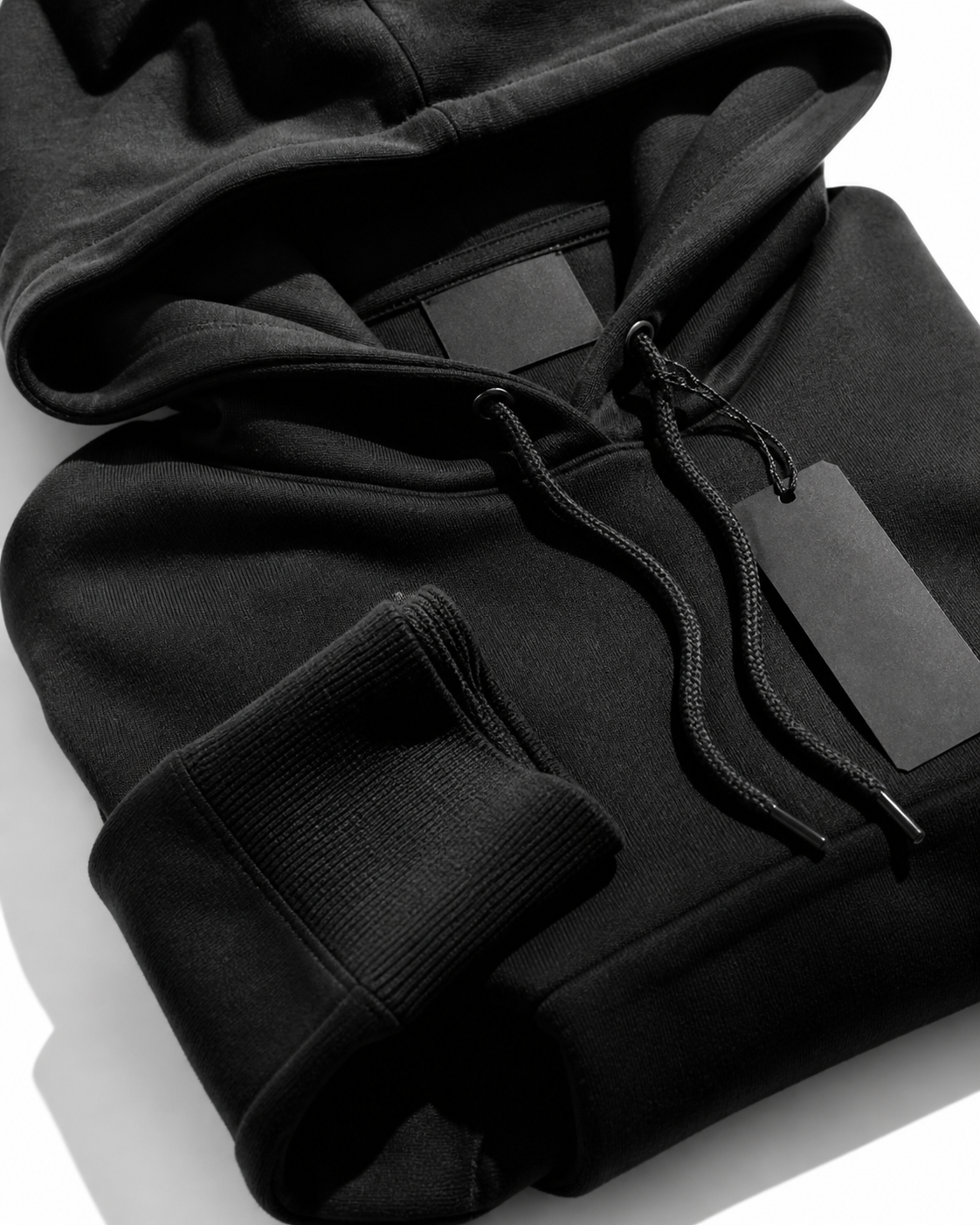 Black and white photographic close-up of a hoodie and fabric texture with no people